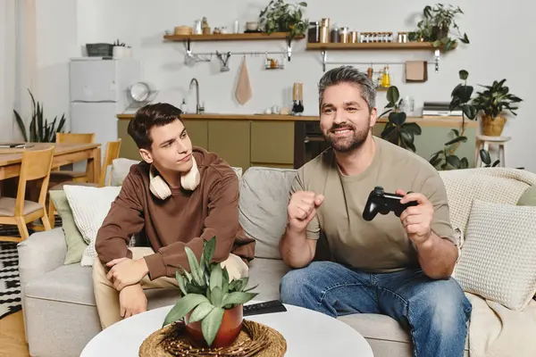 Two brothers share a cozy moment at home while enjoying a game and each others company. — Stock Photo