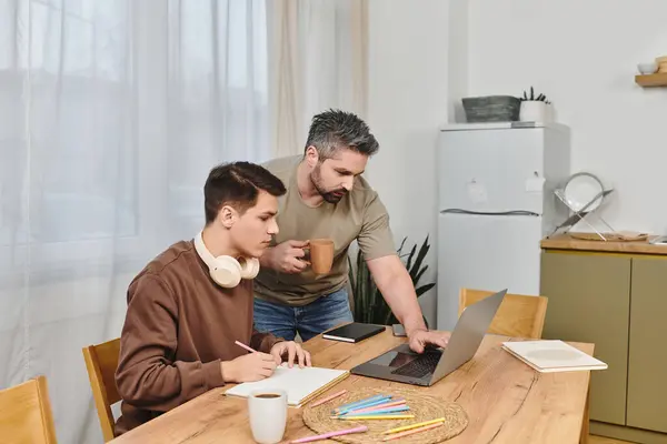 Two brothers enjoy a meaningful moment collaborating at a cozy dining table. — Stock Photo