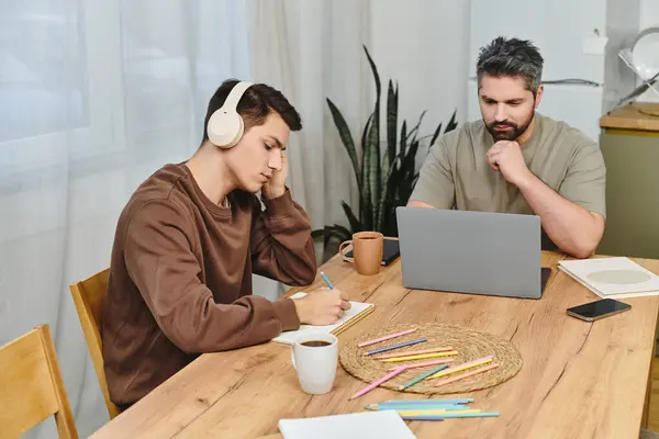 Two brothers engage in a productive study session at home, surrounded by a cozy atmosphere. — Stock Photo