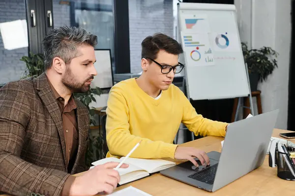Two colleagues work together on the first day of a new job in a contemporary office space. — Stock Photo