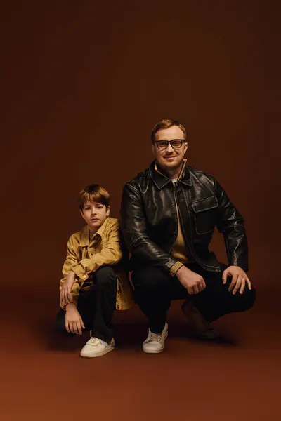 A joyful father and son pose in casual outfits, highlighting their close family bond. — Stock Photo