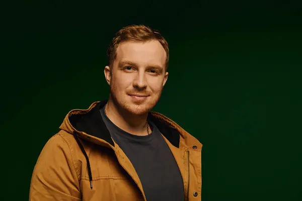 In a stylish studio setting, a handsome man models a casual outfit, exuding confidence and charm. — Stock Photo