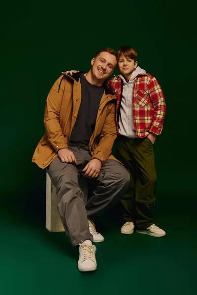 Happy father and son pose together in stylish casual outfits, showcasing family love and bond. — Stock Photo