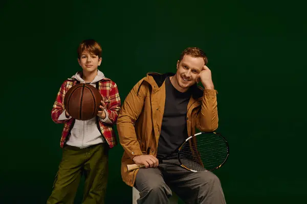 Father and son share a joyful moment in the studio, showcasing their casual fashion flair together. — Stock Photo