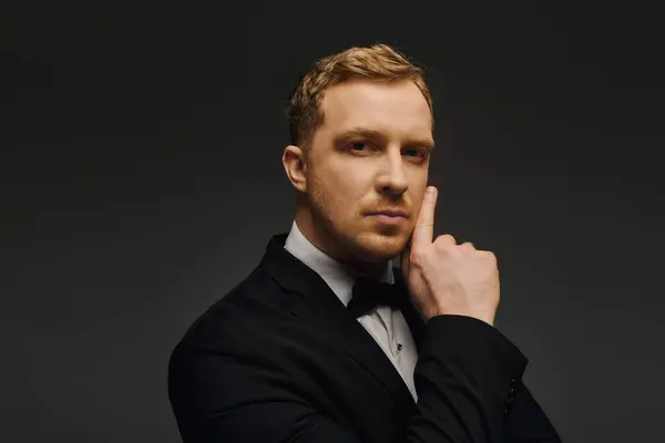 A dapper man poses elegantly in a sophisticated tuxedo, exuding charm and confidence. — Stock Photo