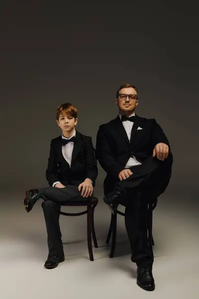 Handsome father and son pose together in stylish tuxedos, exuding elegance and charm. — Stock Photo