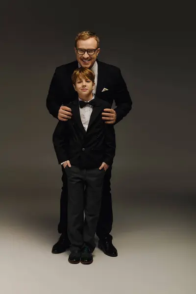 Handsome father and son pose together in elegant bow ties, displaying a bond of sophistication. — Stock Photo