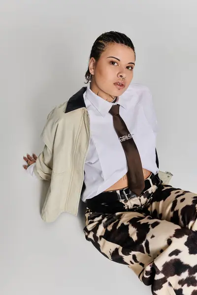 A stylish young woman poses confidently, showcasing her modern look and unique flair. — Stock Photo