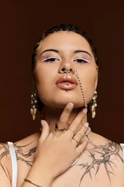 Young woman showcases unique style with accessories and tattoos, exuding confidence and artistry. — Stock Photo