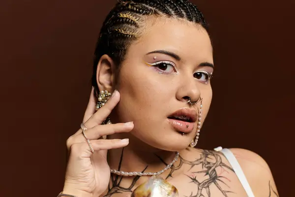 A young woman highlights her unique style through intricate braids and expressive accessories. — Stock Photo