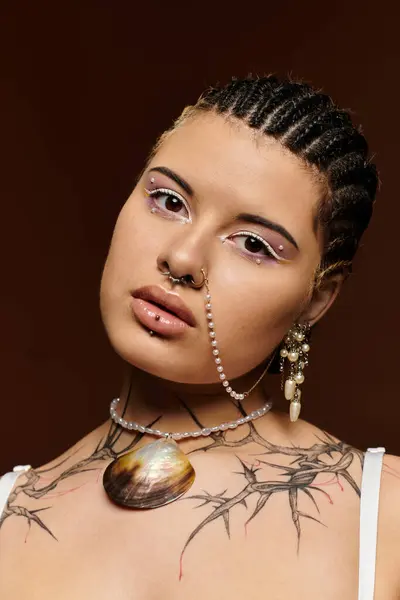 A young woman with braided hair displays striking fashion choices and striking beauty. — Stock Photo