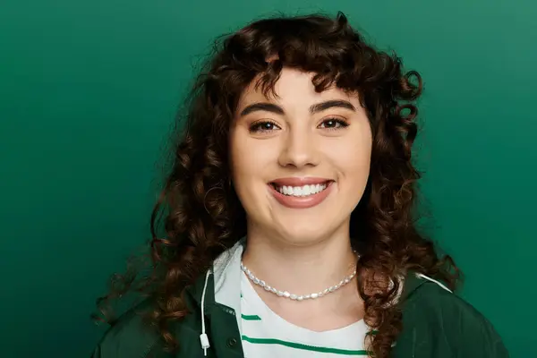 Brightly lit young woman with curly hair exudes joy and style, showcasing her trendy outfit. — Stock Photo