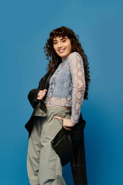A stylish young woman shows her emotions with a pose, highlighting her unique outfit. — Stock Photo