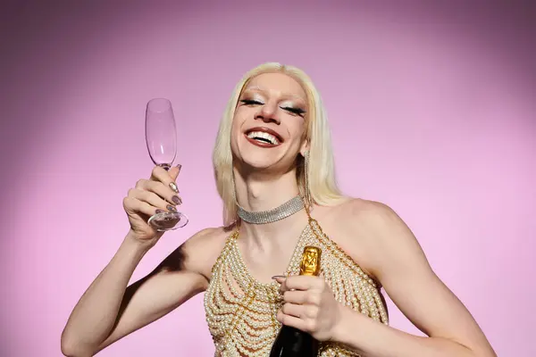 A stylish young drag queen beams with joy, holding a glass and bottle of champagne. — Stock Photo