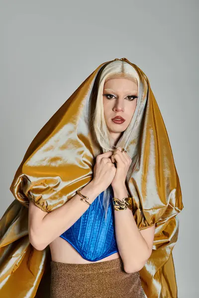 A fashionable drag queen dons a striking outfit and poses with confidence in a stylized setting. — Stock Photo