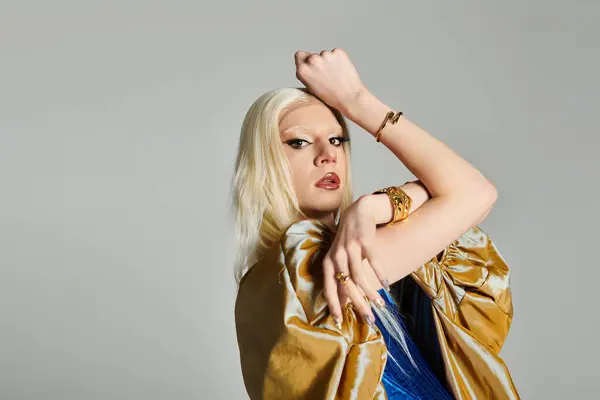 A stylish young drag queen poses confidently against a plain backdrop. — Stock Photo