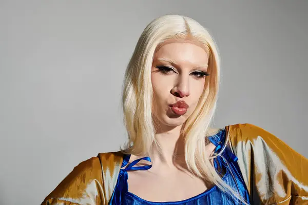 Stylish young drag queen poses confidently in a vibrant outfit with a playful expression. — Stock Photo