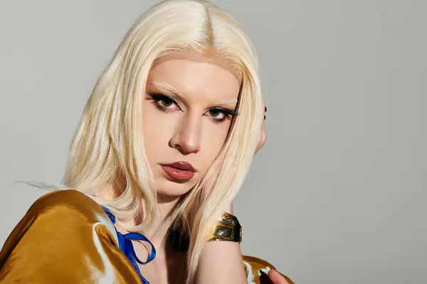 A confident drag queen flaunts their unique style and vibrant personality on a minimal backdrop. — Stock Photo