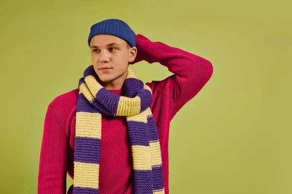 A fashionable young man poses confidently in colorful attire, showcasing his unique style. — Stock Photo