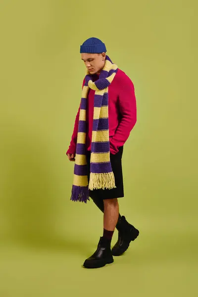 Um jovem elegante com uma perna protética posa elegantemente em um estúdio colorido, exalando confiança. — Fotografia de Stock
