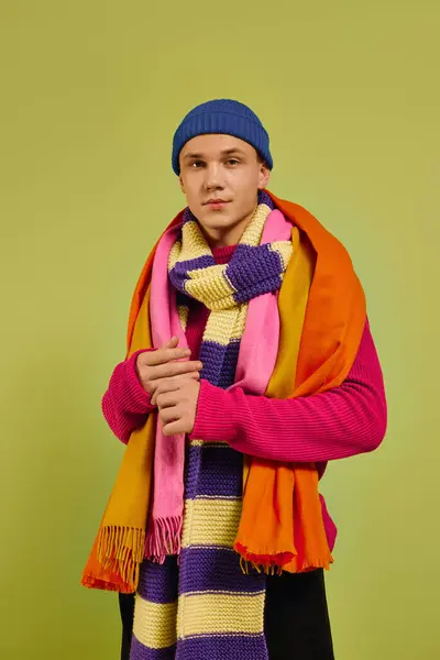 A young man poses confidently in a stylish outfit, showcasing vibrant colors and modern fashion. — Stock Photo