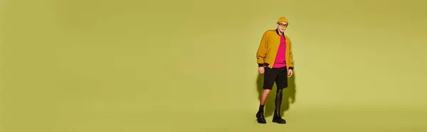 Um jovem posa confiantemente em trajes da moda, apresentando uma perna protética, destacando a inclusão, banner — Fotografia de Stock