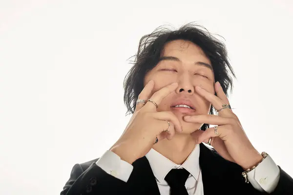 A stylish young Asian male poses artfully, showcasing modern fashion and emotions. — Stock Photo