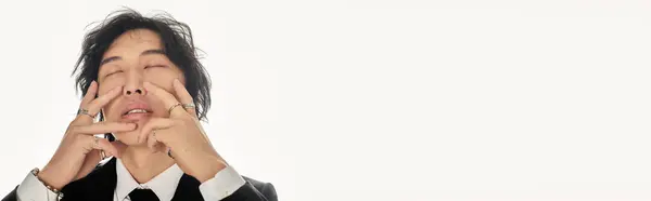 Stylish young man poses thoughtfully in a modern studio, radiating charm and confidence. — Stock Photo