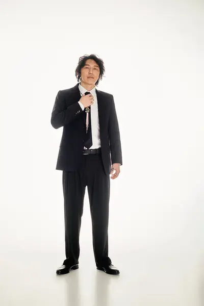 Handsome young asian man exudes confidence while dressed sharply, showcasing contemporary fashion. — Stock Photo