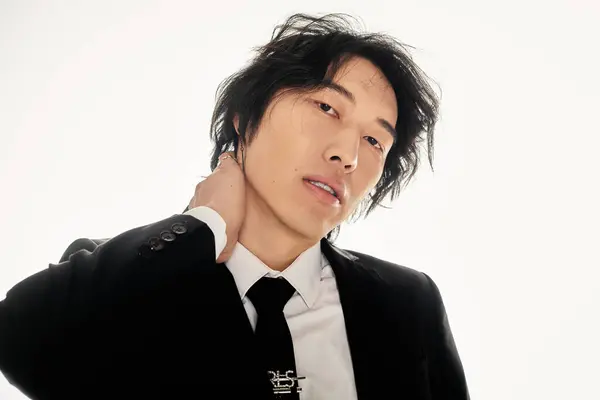 Confident young Asian man displays trendy fashion with understated elegance. — Stock Photo