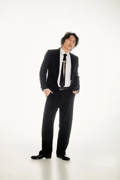 Handsome young asian man stands stylishly in a contemporary environment showcasing trendy fashion. — Stock Photo