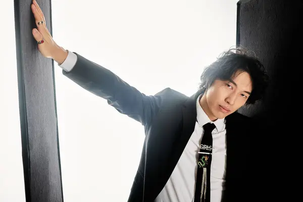 Stylish young man poses against a minimalist backdrop, showcasing his trendy fashion. — Stock Photo