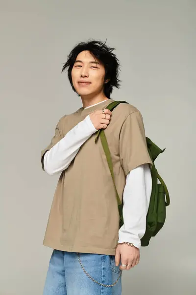 Handsomeness radiates as a young asian man showcases trendy fashion while standing confidently. — Stock Photo