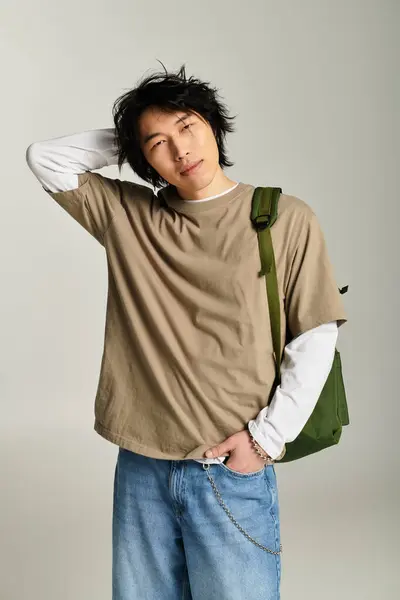 Handsome young asian man poses effortlessly with a trendy outfit in a chic urban studio. — Stock Photo