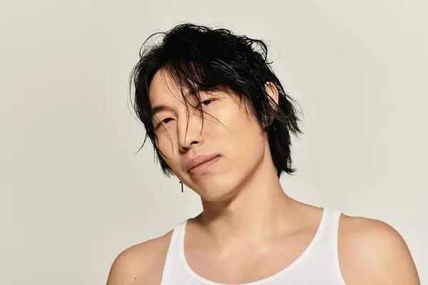 Charismatic young Asian male displays modern elegance with a relaxed pose and effortless style. — Stock Photo