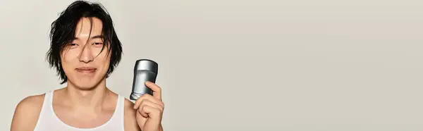 A stylish young man confidently displays his trendy look and chic accessory in a modern setting. — Stock Photo