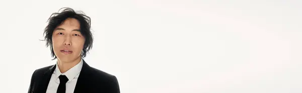 Handsome young asian man stands confidently, showcasing modern fashion with a sophisticated aura. — Stock Photo