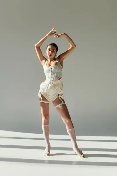 A young gymnast showcases impressive flexibility and stylish flair in her pose. — Stock Photo