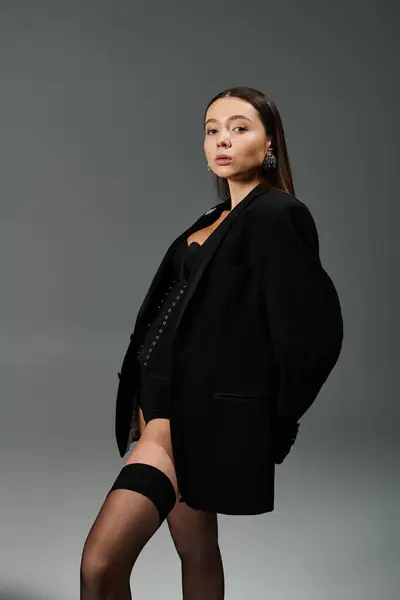 A young woman displays her gymnastic grace in stylish attire. — Stock Photo