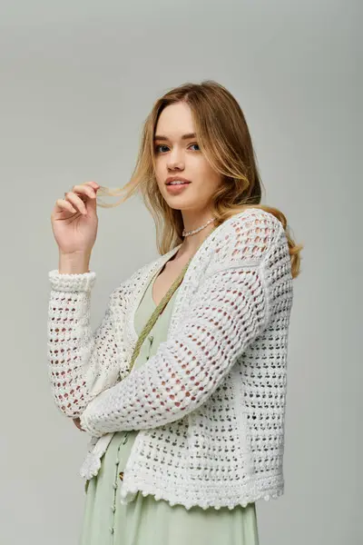 Young woman shows off chic spring wear, exuding confidence in a trendy indoor setting. — Stock Photo