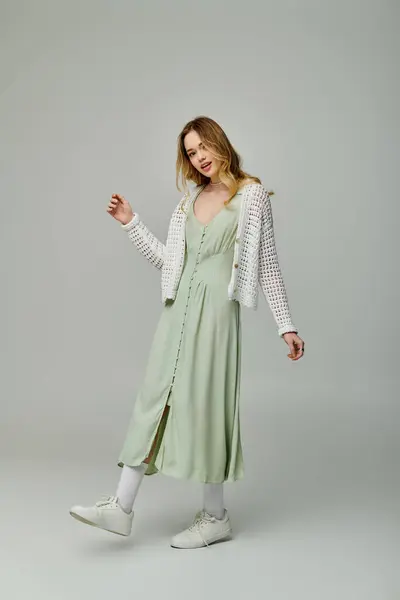 Young woman showcases her playful spirit in stylish spring attire with a cheerful pose and smile. — Stock Photo