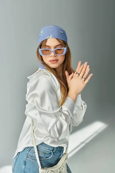 Young woman showcases her spring fashion in a chic studio, infused with vibrant youth energy. — Stock Photo