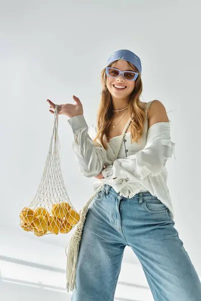 A fashionable young woman showcases her spring style with cheerful colors and a playful attitude. — Stock Photo