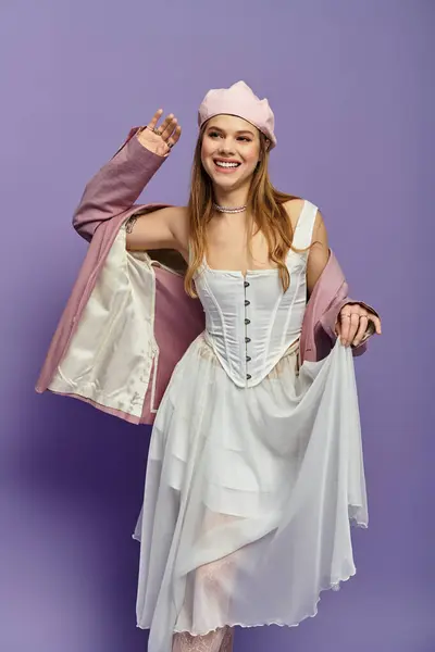 Joyful young woman models a chic spring outfit against a purple backdrop while radiating youth. — Stock Photo