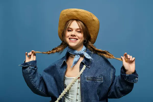 Young woman with braids playfully poses in a stylish denim jacket, embracing spring vibes. — Stock Photo