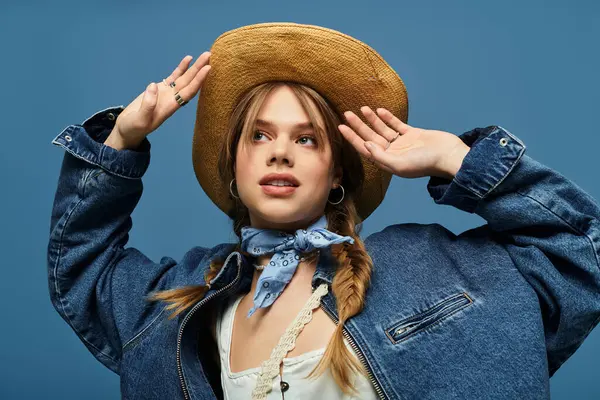 A young woman in a chic denim jacket celebrates spring with a joyful pose in the studio. — Stock Photo