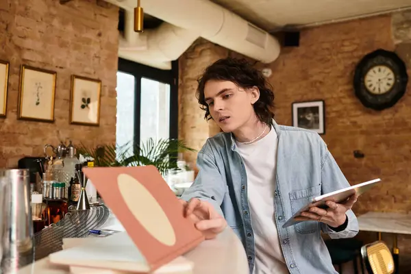 A young man thoughtfully studies the menu at a cozy, welcoming cafe. — Stock Photo