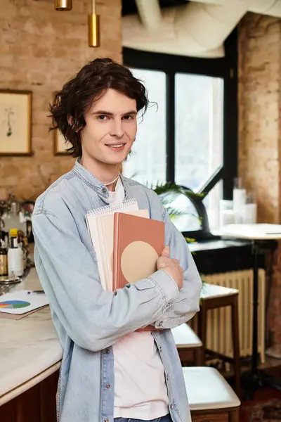 Un giovane uomo si rilassa al suo caffè preferito con quaderni colorati, nel profondo del pensiero. — Foto stock