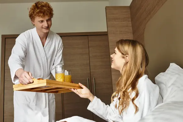 A loving couple enjoys a delightful breakfast in their hotel room, creating cherished memories. — Stock Photo