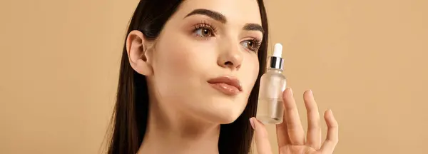 A young woman showcases her radiant skin while exploring beauty and skincare product, banner — Stock Photo